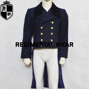 May include: A navy blue tailcoat with a black velvet collar and gold buttons. The coat has a long tail and is worn over a white shirt. The text "REGIMENTAL WEAR" is visible on the front of the coat.