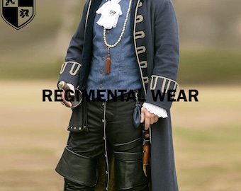 May include: A navy blue long coat with gold trim, worn over a blue vest and white shirt with a ruffled collar. The outfit includes black leather pants and a decorative necklace. The text "REGIMENTAL WEAR" is displayed.