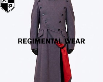 May include: A long, grey, double-breasted coat featuring a high collar, shoulder epaulets, and dark buttons. The coat has a prominent red lining visible at the front opening. The text REGIMENTAL WEAR is printed across the centre of the image.