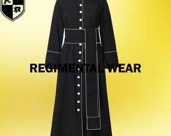 May include: A black long-sleeved robe with white piping and a white sash. The robe has a button-up front and a collar.