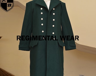 May include: A dark green long coat featuring a high collar, long sleeves, and a double-breasted front with two columns of silver-toned buttons. The garment includes two side pockets with flaps and displays the text REGIMENTAL WEAR.