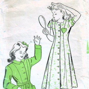 May include: A vintage sewing pattern for a green dress with a white collar and buttons. The pattern is for size 6 and is from New York Gold Seal. The pattern is from 1917 and costs 15 cents.