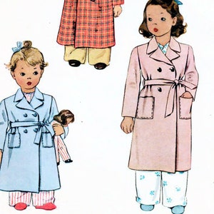 May include: Vintage McCall's sewing pattern for a child's bathrobe. The pattern shows three children wearing different styles of bathrobes: a red and black checked bathrobe, a pink bathrobe, and a light blue bathrobe. The pattern number is 5431, size 4.