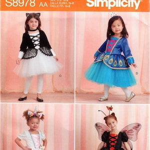 May include: Simplicity pattern S8978 features four children's costume designs. The costumes include a cat, peacock, unicorn, and butterfly. The pattern includes sizes 1/2-2 and is marked "Since 1927".