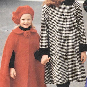 May include: A red cape with a matching beret and a black and white houndstooth coat with a black collar, black cuffs, and a matching houndstooth beret. The red cape features a circular floral accent at the neckline and the letter C. The coat features the letter B.
