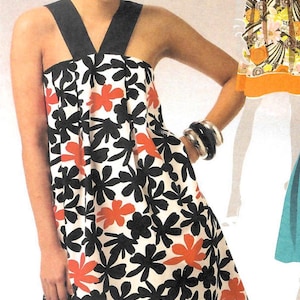 May include: A sleeveless dress with a floral pattern. The dress features a white background with black and orange flower designs. It has a black neckline and straps. The model is wearing silver bracelets.