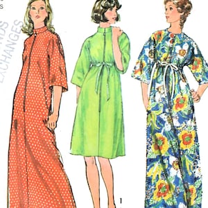 May include: Three vintage dresses with zip-up fronts are shown. The first is a long, orange dress with white polka dots. The second is a knee-length, green dress with a matching belt. The third is a long, blue dress with a floral pattern.