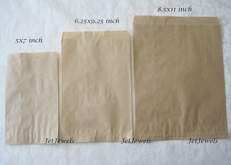 May include: Three brown paper bags of different sizes. The bags are labeled with their dimensions in inches: 5x7 inch, 6.25x9.25 inch, and 8.5x11 inch. The bags are all from JetJewels.
