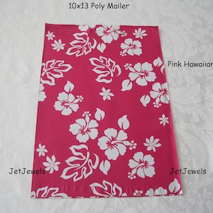 May include: A rectangular 10x13 poly mailer featuring a vibrant pink background with a repeating white hibiscus flower and leaf pattern. The text 10x13 Poly Mailer, Pink Hawaiian, and JetJewels are printed on the surface of the shipping bag.