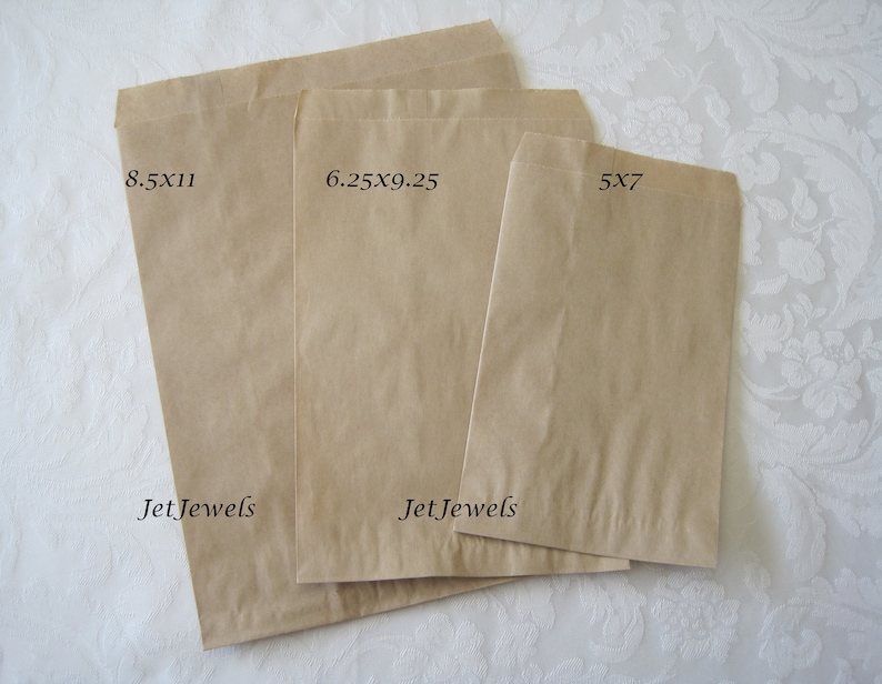 May include: Three brown paper bags of different sizes. The largest bag is 8.5 x 11 inches, the middle bag is 6.25 x 9.25 inches, and the smallest bag is 5 x 7 inches. All bags have the text "JetJewels" printed on them.