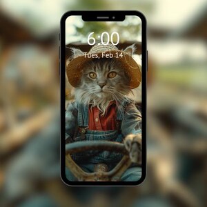 May include: A gray cat wearing a straw hat and overalls is driving a tractor. The phone screen shows the time as 6:00 and the date as Tues, Feb 14.