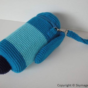May include: A crocheted blue and teal zippered pouch with a long strap. The pouch is striped with a dark blue, light blue, and teal yarn.