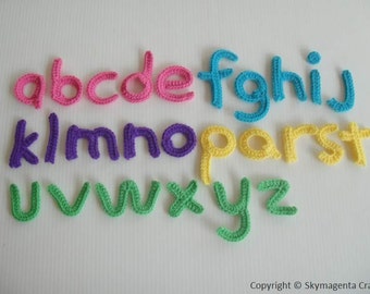 May include: A set of colourful crocheted letters of the alphabet, from a to z, in pink, purple, yellow, and green.