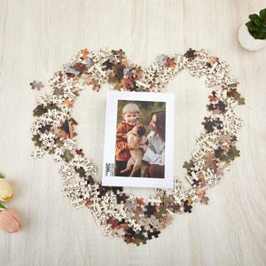 May include: A 300 piece jigsaw puzzle with a photo of a child and a dog. The puzzle pieces are scattered around a white box with the text "300 pieces" on it.