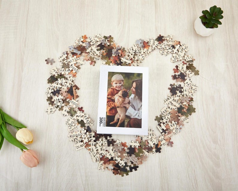 May include: A 300 piece jigsaw puzzle with a photo of a child and a dog. The puzzle pieces are scattered around a white box with the text "300 pieces" on it.