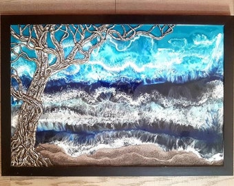 Seascape epoxy resin painting with real sand beach, foamy waves in deep blues with turquoise and grey and three dimensional tree sculpture