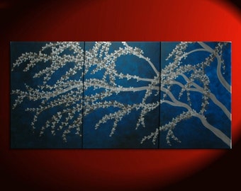 May include: A three-panel abstract painting depicting a stylized silver tree with white blossoms against a deep blue background.
