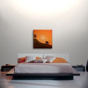 May include: A painting of an elephant walking on a hill with a tree in the background. The sky is orange and the sun is setting.