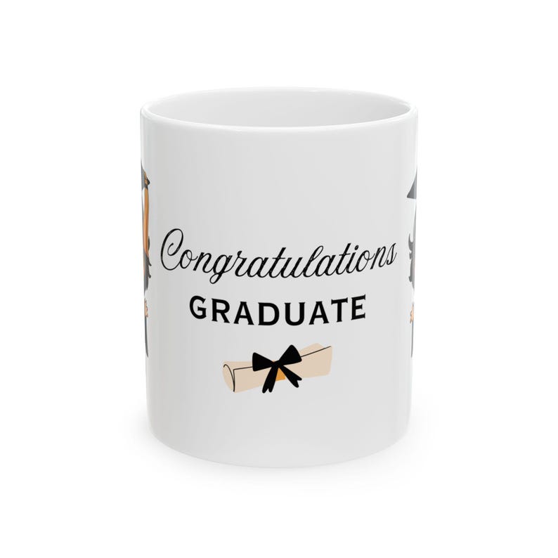 May include: White ceramic coffee mug with a black and white illustration of a graduation cap, a diploma, and the text "Congratulations GRADUATE".