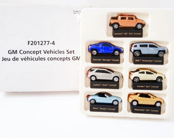 Maisto Showcase Collection featuring 1:64 scale model cars from 2001 General Motors GM concept Vehicles, name plate stands, Executive desk
