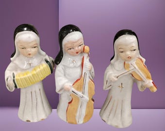 Three 1950s Ceramic Nuns with Musical Instruments, Band of Nuns, Violin, Cello Accordion