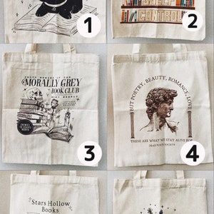 May include: A collection of six canvas tote bags with various book-themed designs. The designs include a black cat with the text "Life is Better with Cats & Books", a bookshelf with the text "I Have No Shelf Control", and a skull with the text "Morally Grey Book Club".