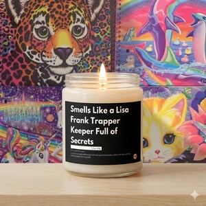 May include: A burning candle in a clear glass jar with a black label. The label says "Smells Like a Lisa Frank Trapper Keeper Full of Secrets." The background displays colourful Lisa Frank-style artwork, including a leopard, dolphins, and unicorns. The candle weighs 255g.