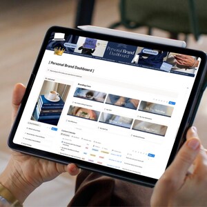 May include: A black tablet displaying a "Personal Brand Dashboard" interface. The screen shows various sections like "Branding Core" and "Content Calendar." A white stylus rests on top. The tablet is held in someone's hands.