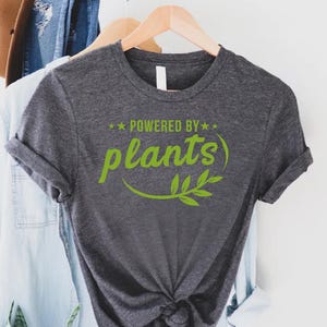 Powered By Plants T-Shirt, Vegan Lifestyle Tee, Plant Based Graphic Shirt, Eco Friendly Vegan Tee, Healthy Living Shirt, Plant Power Apparel