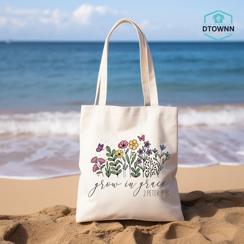 a white tote bag sitting on top of a sandy beach