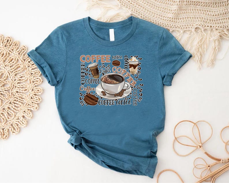 May include: A teal blue t-shirt featuring a coffee cup and coffee beans graphic. The graphic includes the word "Coffee" repeated multiple times.