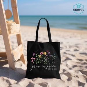 a black bag sitting on top of a sandy beach