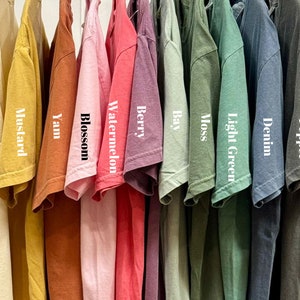 a bunch of shirts hanging on a rack