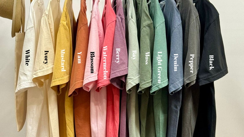 a bunch of shirts hanging on a rack