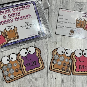 May include: A set of educational game cards featuring cartoon images of peanut butter and jelly sandwiches. The cards are designed to help children learn about money and counting coins. The cards include different amounts of coins, ranging from 84 pence to £1.22. The cards also include a title card that says "Peanut Butter & Jelly Money Match" and a skill card that says "Mixed Coins £2.00".