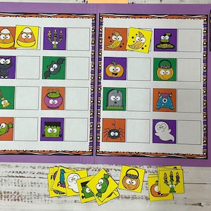 May include: A purple Halloween-themed learning activity. The open folder displays colorful illustrations of Halloween icons, such as candy corn, bats, and ghosts. Matching cards are scattered below. The folder has a decorative border.