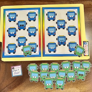 May include: A yellow file folder with a rainbow border, featuring cartoon buses with various facial expressions. Additional green buses with different expressions are scattered below. A small label reads "Teena Fisher July 2024".