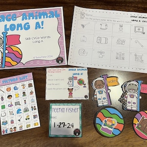 May include: A set of educational materials for teaching long A sounds in words. The set includes a picture list, a worksheet, and several colorful cards featuring space animals with flags that say "wake" and "gate".