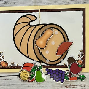 May include: A brown cornucopia with a variety of fall harvest foods, including a butternut squash, a sweet potato, a red apple, a green pear, a bunch of grapes, a green pea pod, a red bell pepper, a yellow onion, and a carrot. The cornucopia is on a yellow background with a brown border. The text "Classroom Helpers" and "Enrichment Learning" is on the top right corner of the image.