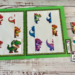 May include: A green folder with a dinosaur puzzle activity. The folder has a clear plastic pocket on the front with a label that says "June 2024". The puzzle pieces are colorful and feature different dinosaurs.