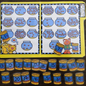 May include: A yellow folder with a counting activity for kids. The folder has a picture of fish bowls with different numbers of fish in each bowl. There are also small cans of fish food with numbers on them. The text on the folder says "Feed the fish!" and "Counting 1-20".