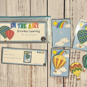 May include: Educational set with the text "IN THE AIR! Errorless Learning." Includes cards with hot air balloons, rainbows, and clouds. A clear zippered pouch holds the cards. The set is designed for skill task completion.