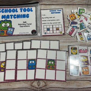 May include: A school tool matching game with cards and mats. The game includes a clear zippered pouch with the title "SCHOOL TOOL MATCHING" and the skill "Matching Facial Expressions". The game features colorful illustrations of school supplies.