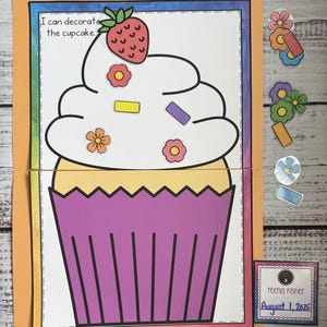 May include: A colorful educational activity featuring a large cupcake illustration with a strawberry and flower decorations. The text "I can decorate the cupcake" is visible. The folder includes the text "CUPCAKE! Errorless Learning".