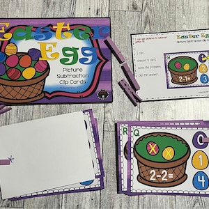 May include: Purple and white Easter Egg themed picture subtraction clip cards. The cards feature a basket with colorful eggs and a subtraction problem. The answer is to be clipped to the card with a clothespin.