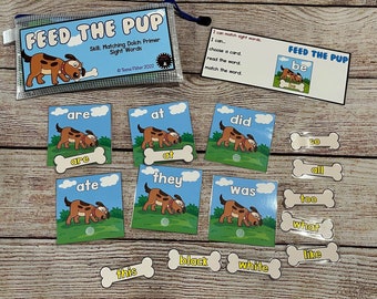 May include: A set of educational flashcards for children featuring a cartoon dog and the words "Feed the Pup". The cards are designed to help children learn sight words and match them to the corresponding image. The cards are printed on white cardstock with colorful illustrations and text.