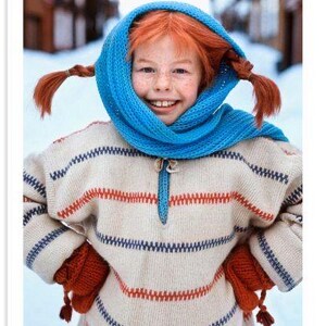 May include: A portrait of a smiling child with red braids, wearing a blue scarf and a cream-colored sweater with red and blue stripes. The child is also wearing red mittens. The image is set in a snowy outdoor scene.
