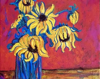 May include: An original oil painting of sunflowers in a blue glass vase. The sunflowers are yellow with dark centers and blue stems, set against a red and orange background. The painting has a textured, impressionistic style.