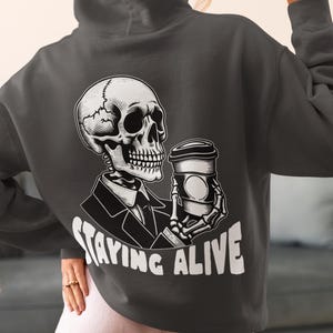 Staying Alive Skeleton Hoodie, Funny Goth Hoodie, Funny Skeleton Sweater, Halloween Hoodie, Dark Humor Skull Hoodie, Cozy Gothic Pullover