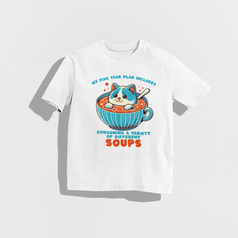 May include: White t-shirt featuring a cartoon cat in a bowl of soup. The text on the shirt reads "My five year plan includes consuming a variety of different soups."